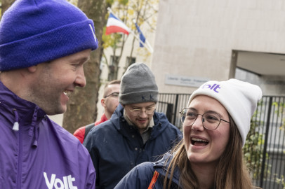people in purple laughing and holding Volt flyers