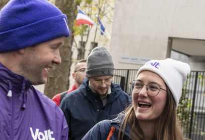 people in purple laughing and holding Volt flyers