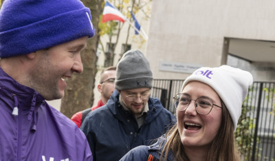 people in purple laughing and holding Volt flyers