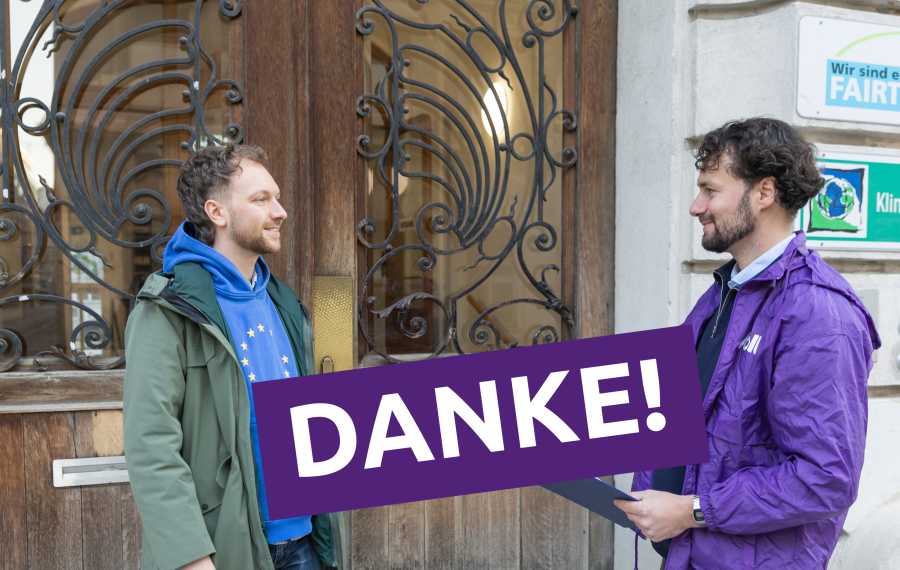 lead candidate Marek talking to someone and a big sign saying