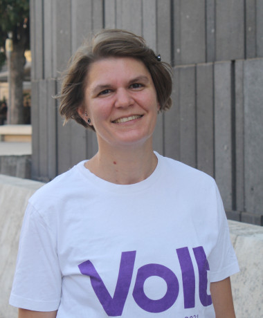 Photo of Karoline Adam standing in the Museumsquartier Vienna, smiling